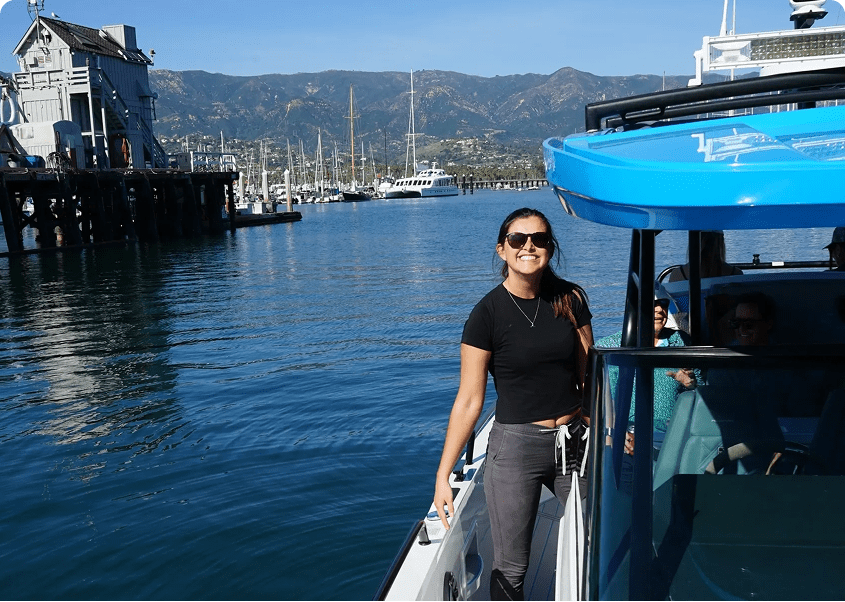 Woman smiling on a boat by the pier